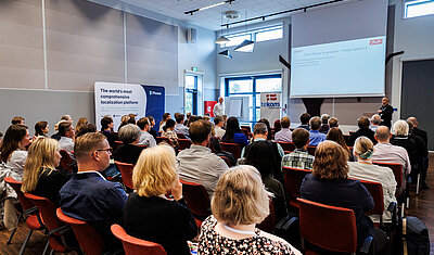conference attendees sitting in rows listening to a presentation